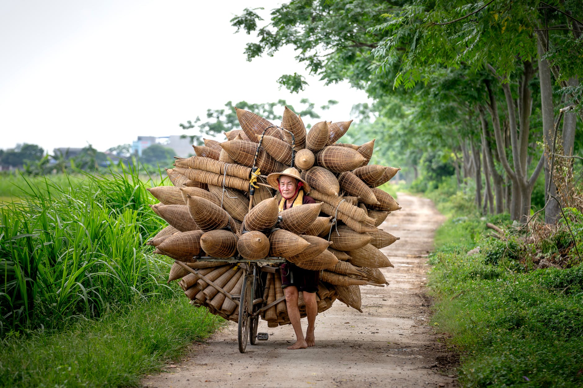 senior woman with traditional bamboo fish traps