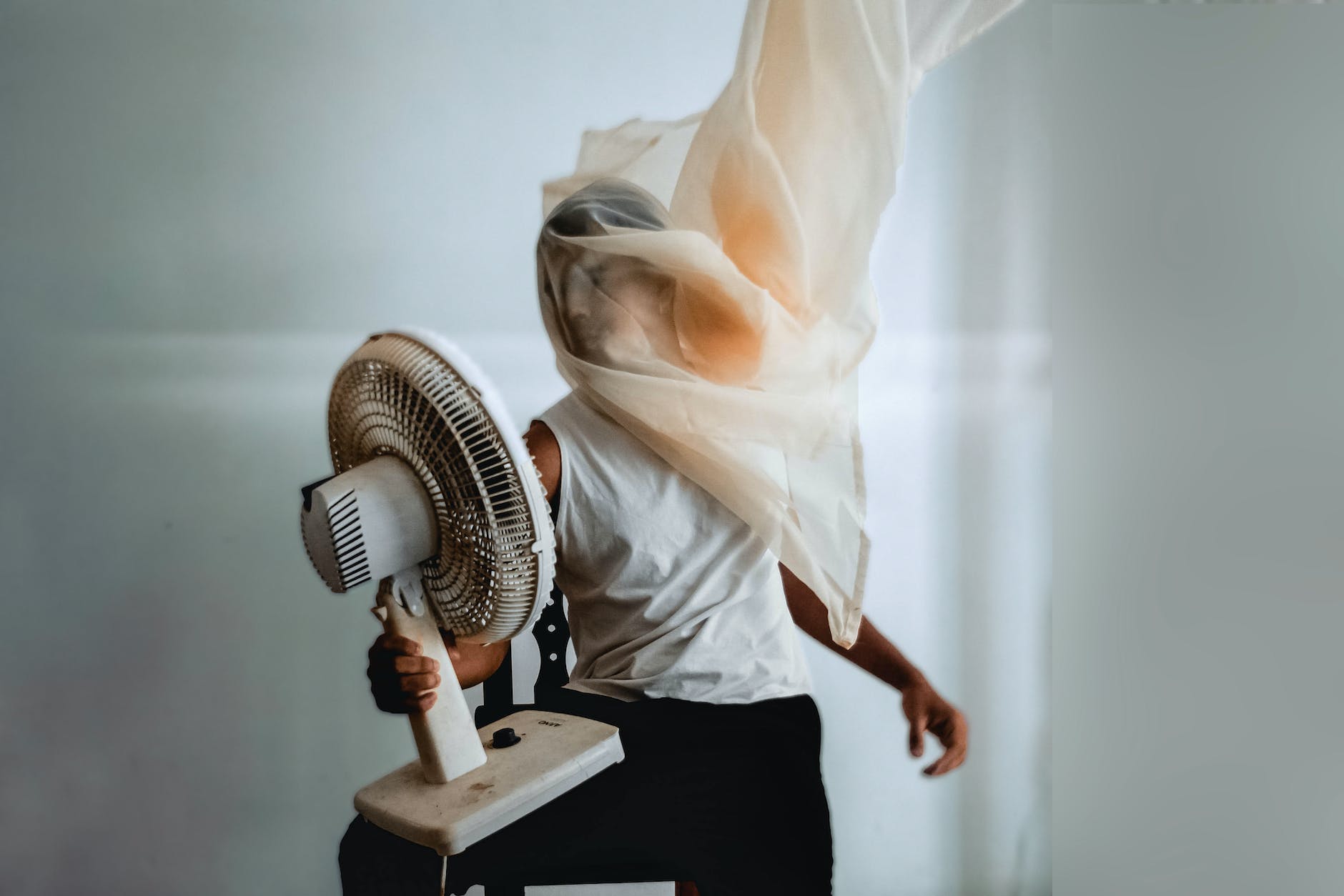 photo of person holding electric fan