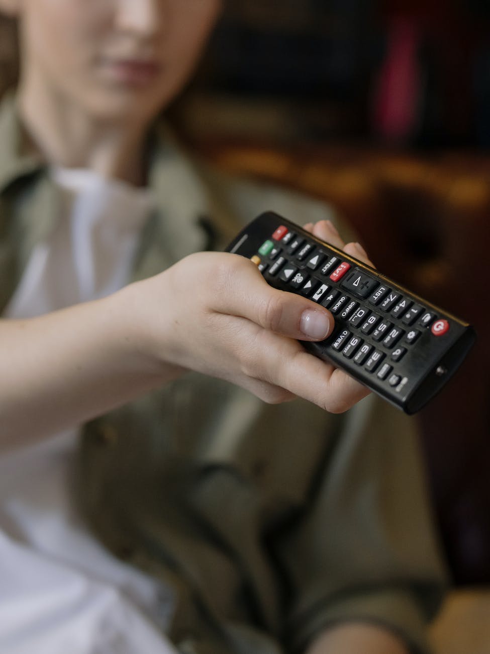 person holding black remote control